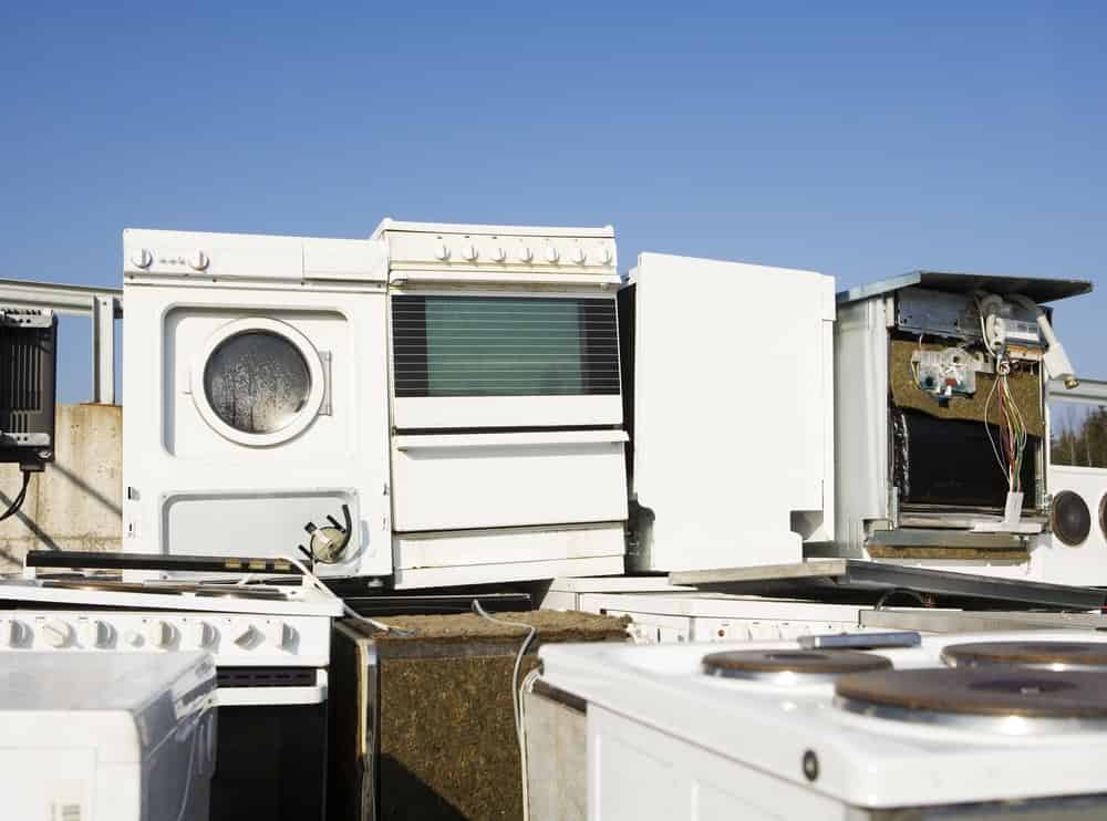 pile of old appliances in need of appliance removal services