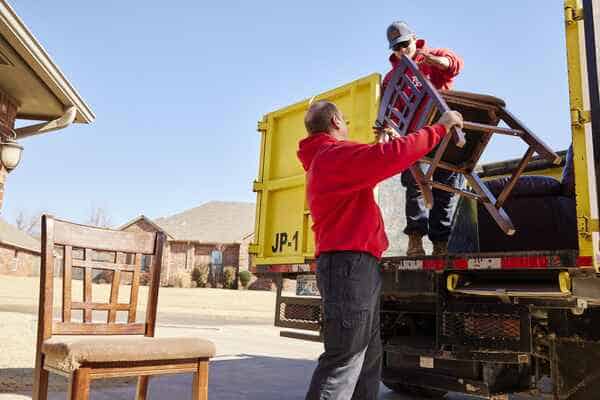 loading junk chairs into the junk removal truck in Edmond