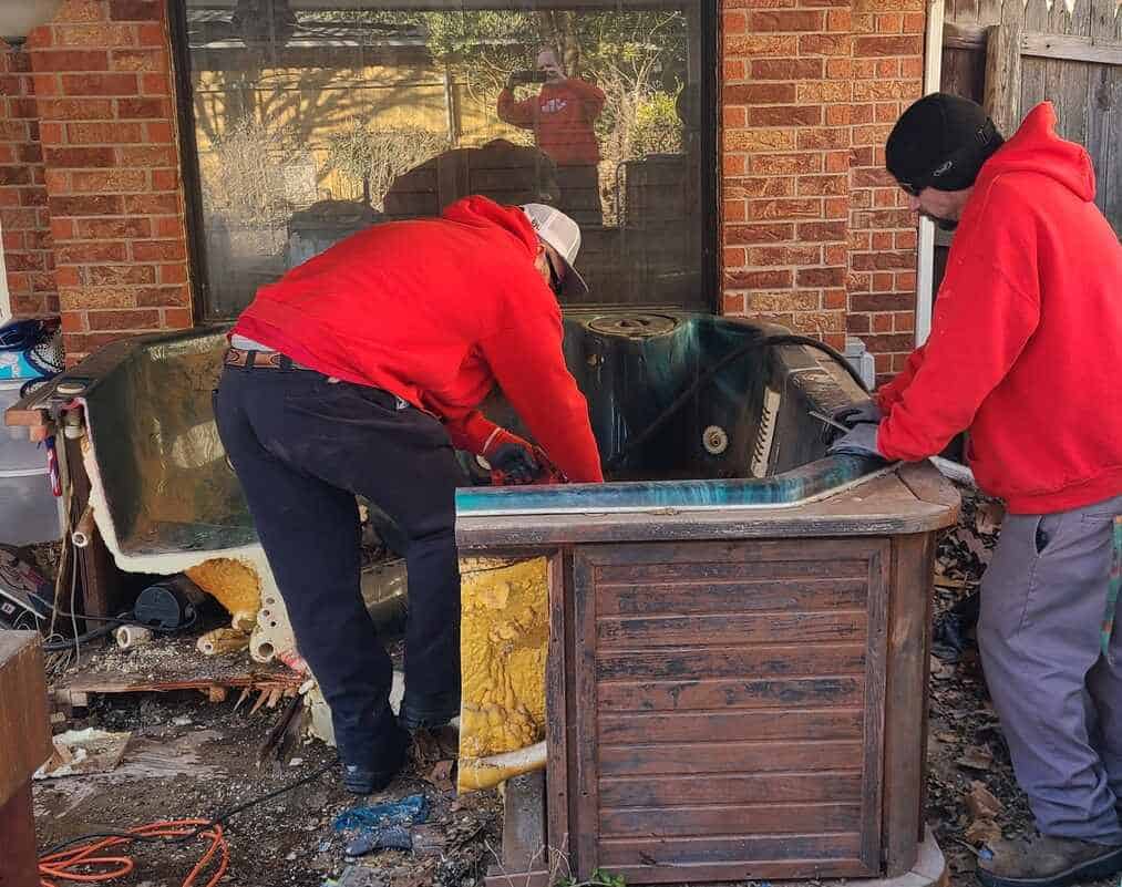 junk removal experts removing a hot tub in Edmond, OK