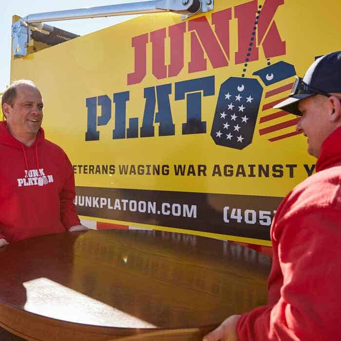 junk removal technicians remove table from an oklahoma city apartment cleanout